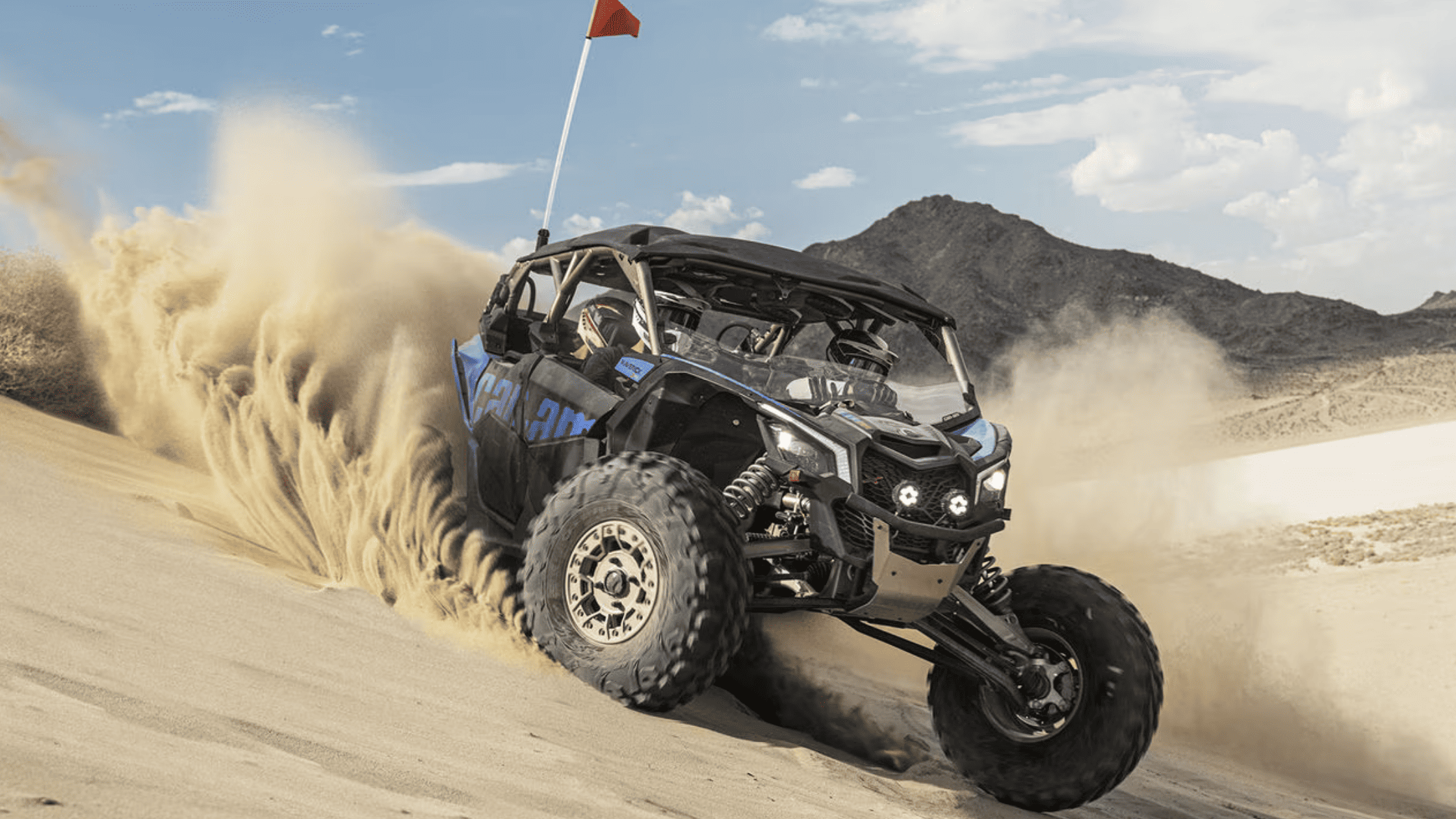 2024 Can-Am Maverick X3 tearing through sand dunes, showcasing off-road power.