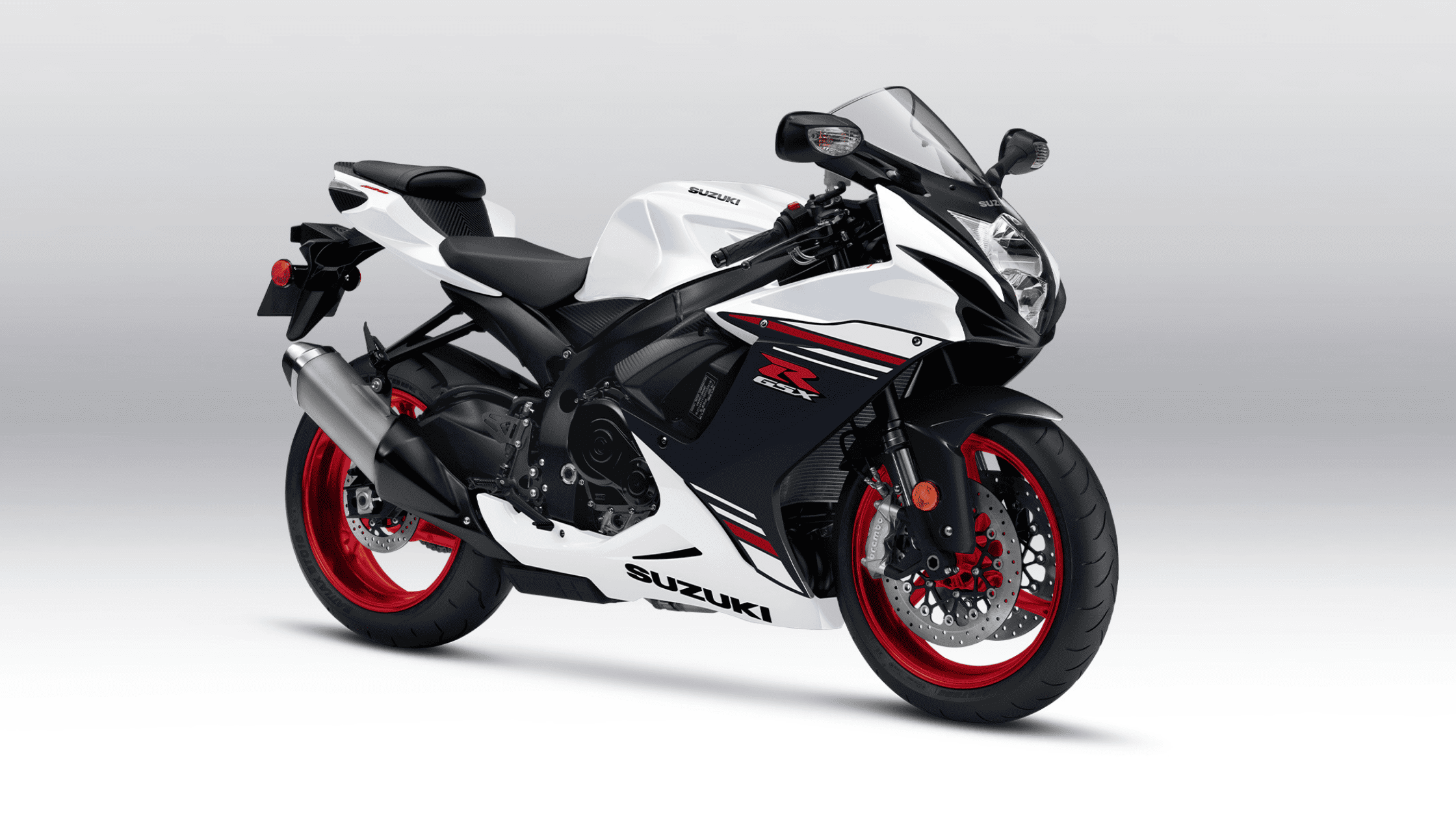 White, blue, and red 2025 Suzuki GSX-R600 sportbike on a gray backdrop.